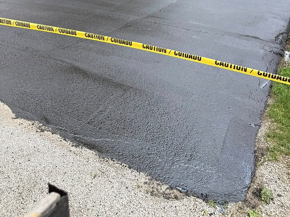 The same driveway after Campbell's seal coat — deep wet black