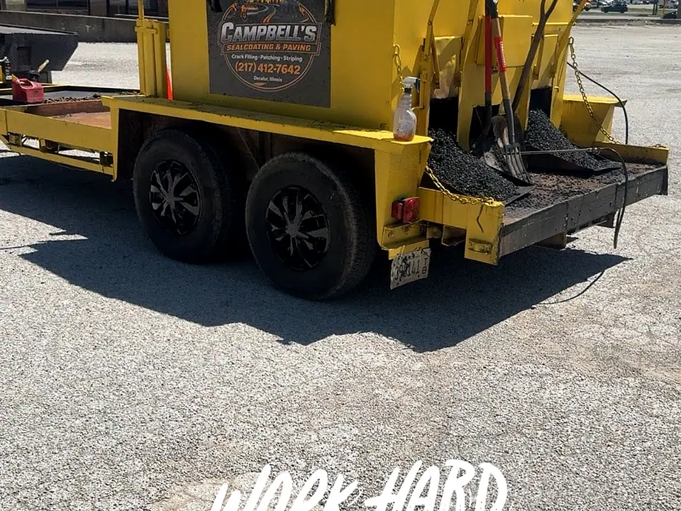 Campbell's yellow branded trailer — Work Hard, Stay Humble