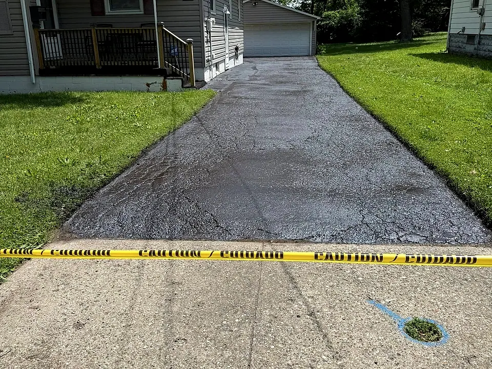 Crew working a residential driveway job edge to edge