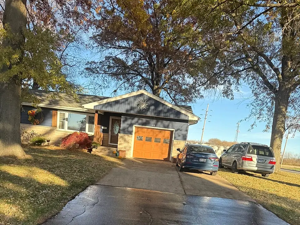 Freshly seal-coated residential driveway with a deep wet-black finish
