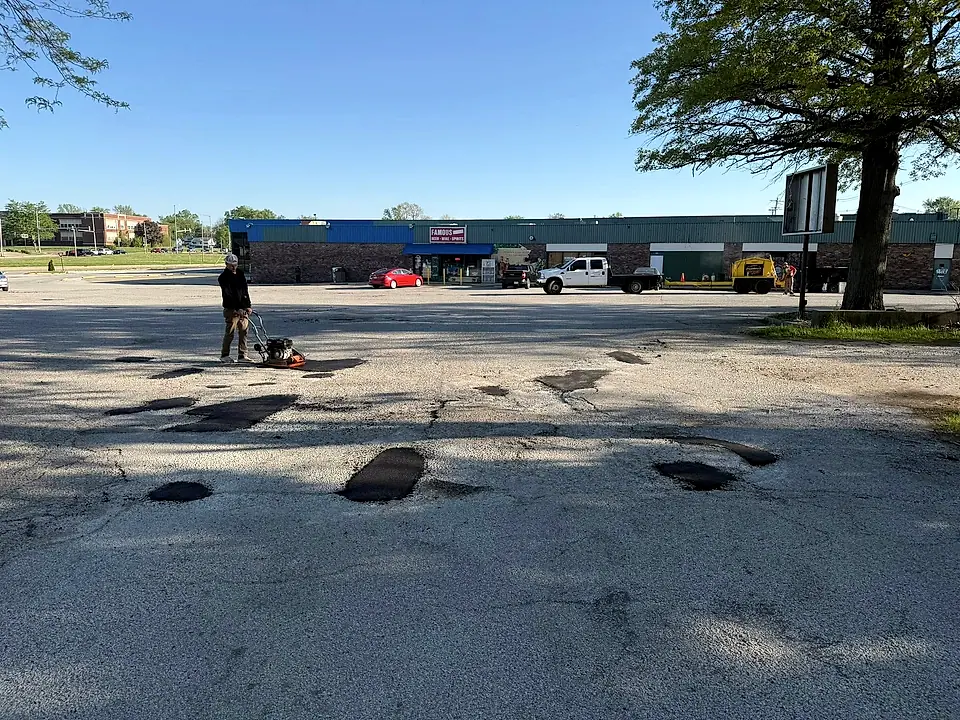 Large commercial lot with extensive cracking being worked